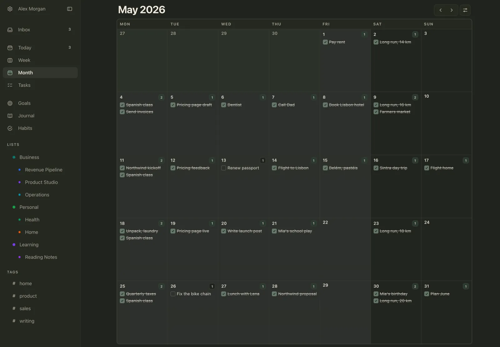 Plannedo's Month view for May 2026 on a Mac: most days have one or two tasks crossed out as done, such as Flight to Lisbon, Pricing page live and Mia's birthday, while Renew passport on May 13 and Fix the bike chain on May 26 are still unticked.