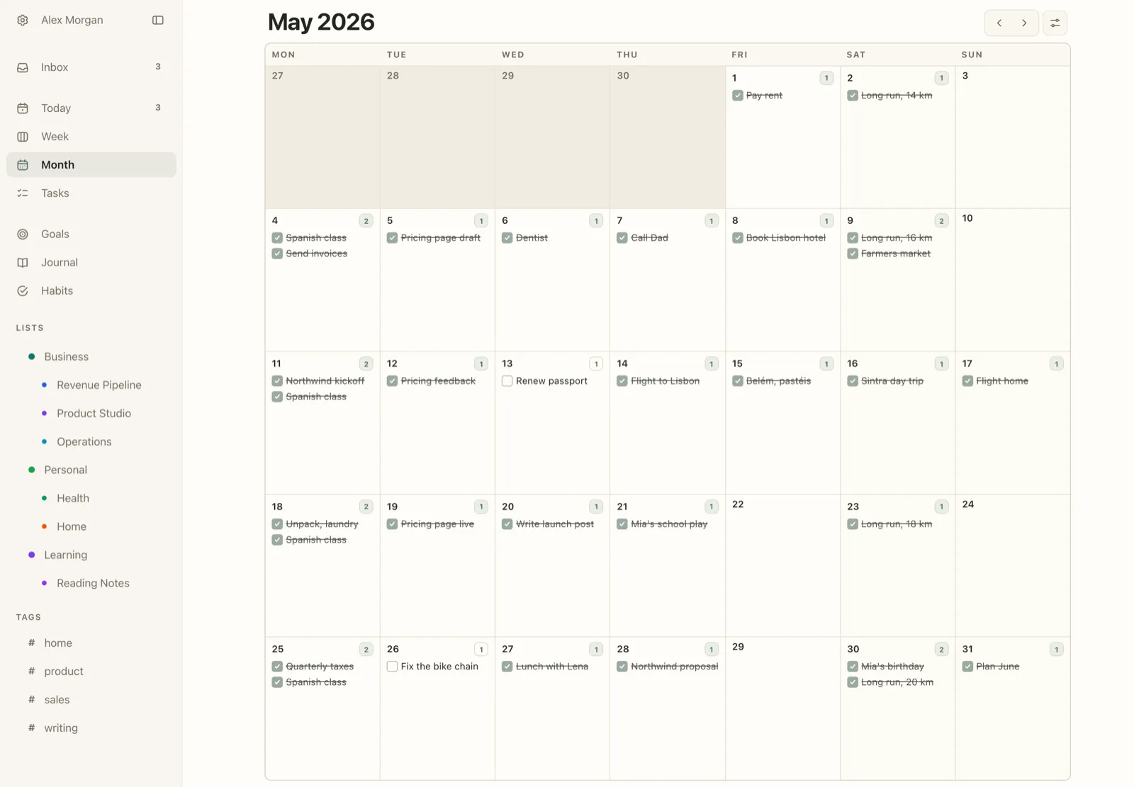 Plannedo's Month view for May 2026 on a Mac: most days have one or two tasks crossed out as done, such as Flight to Lisbon, Pricing page live and Mia's birthday, while Renew passport on May 13 and Fix the bike chain on May 26 are still unticked.